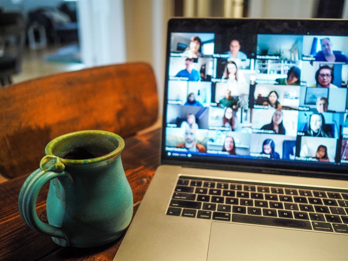 Laptop in a home environment. The laptop is running a video conference.