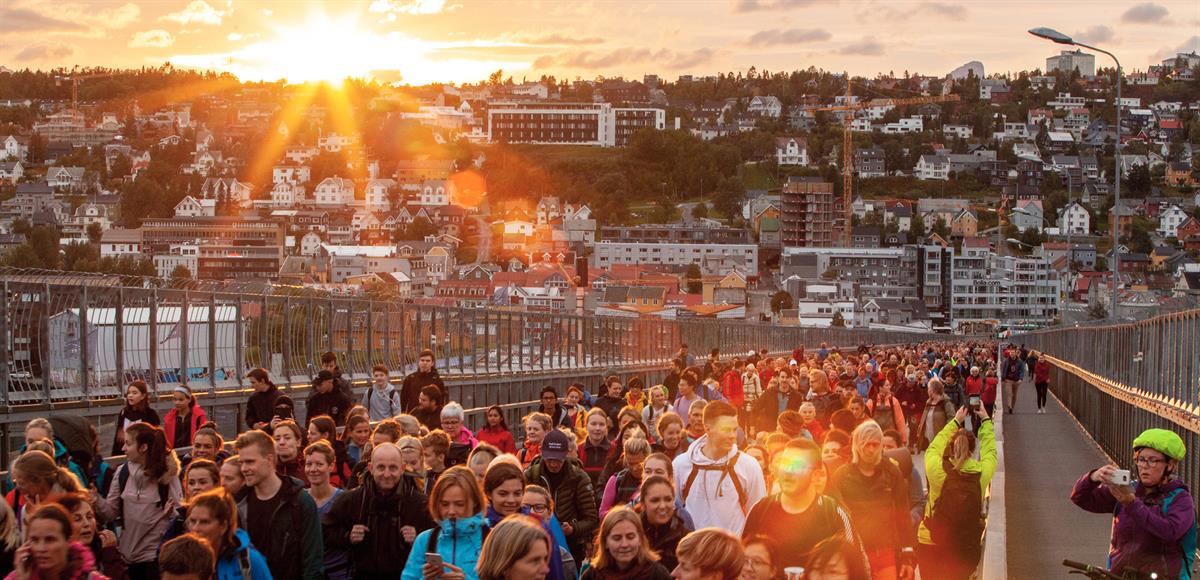 Picture of a group of people crossing a bridge together