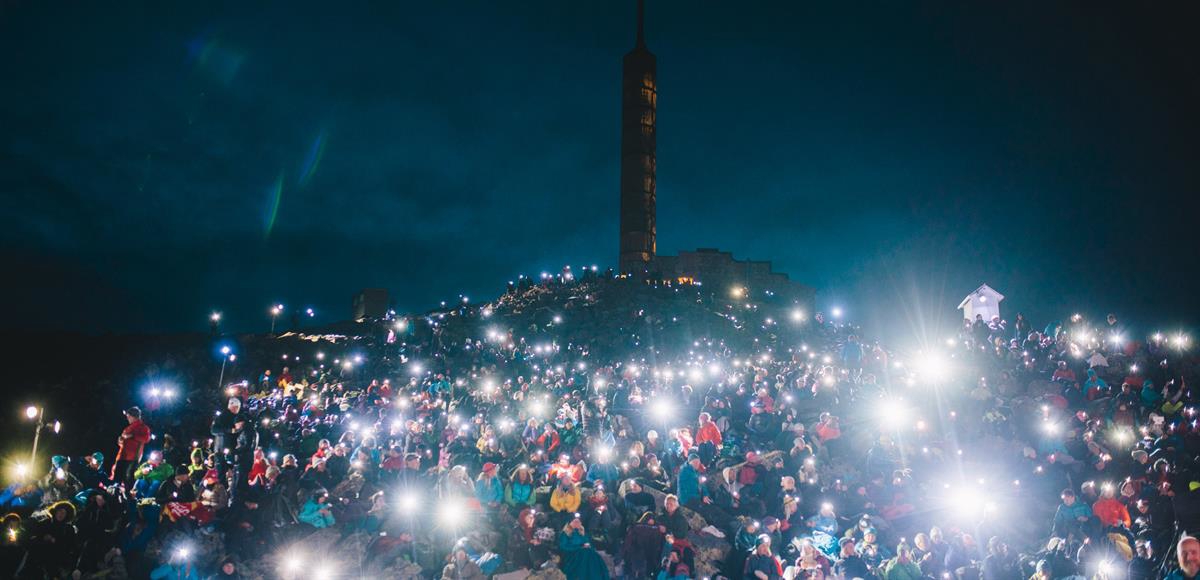 Picture of a gathering of people in a park.