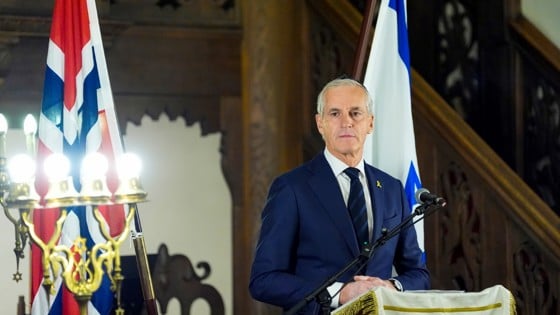 The Prime Minister standing behind a speech stand.