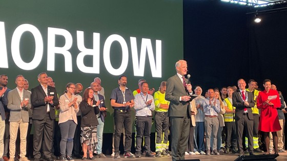 Prime Minister on stage with employees of Morrow.