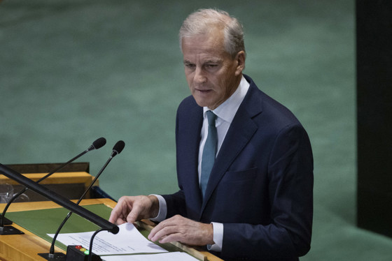 The Prime Minister behind a speechstand with a script.